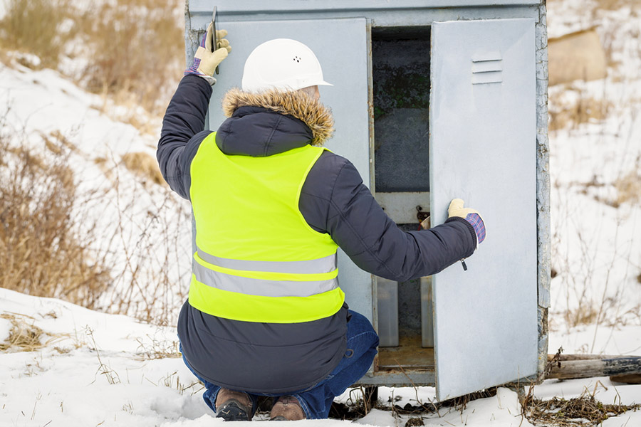 Railroad worker checking electrical enclosures