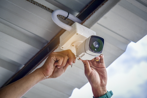 Technician installing CCTV camera