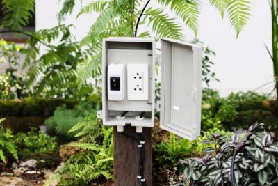 The power outlet in the protection or safety box with stand outside at the garden