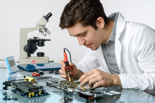 engineer repairng electronic equipment